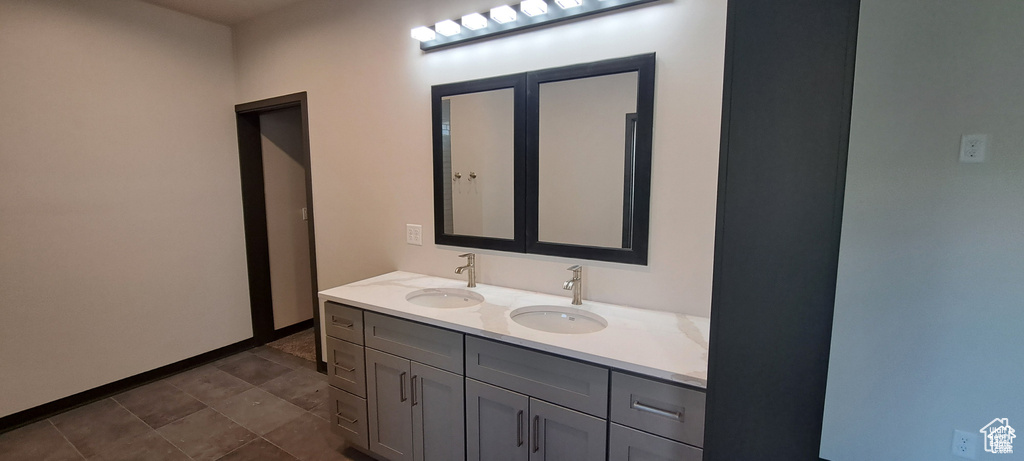 Bathroom featuring double vanity and tile floors