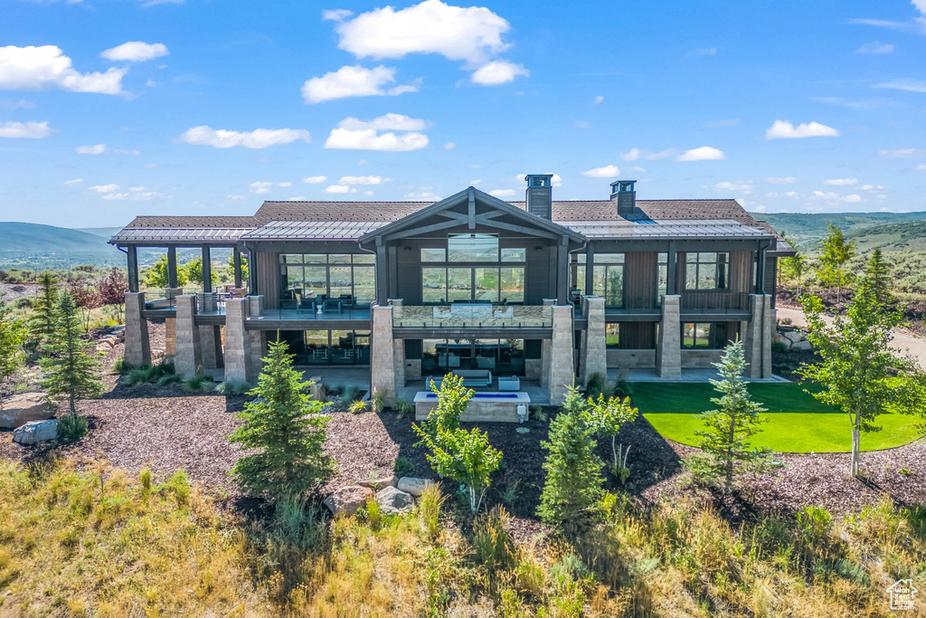 Back of property featuring a balcony