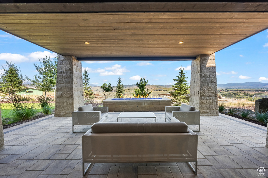 View of patio / terrace with an outdoor living space and a mountain view