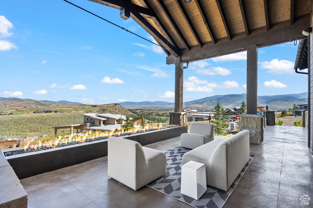 View of patio with an outdoor living space and a mountain view