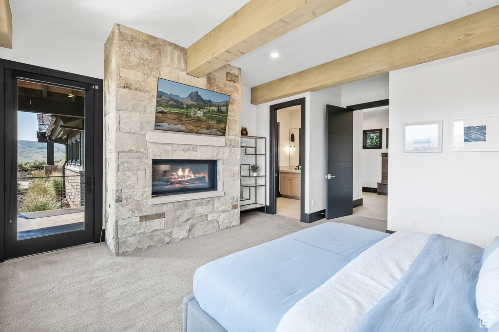 Bedroom featuring beam ceiling, access to outside, ensuite bathroom, and light colored carpet