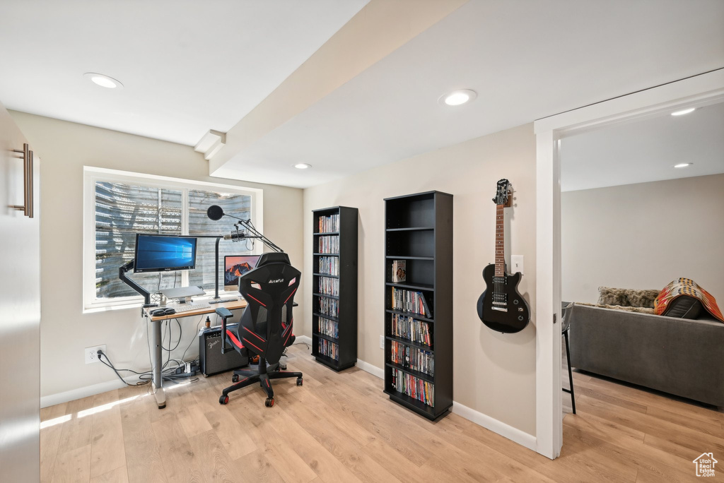 Office space with light hardwood / wood-style floors