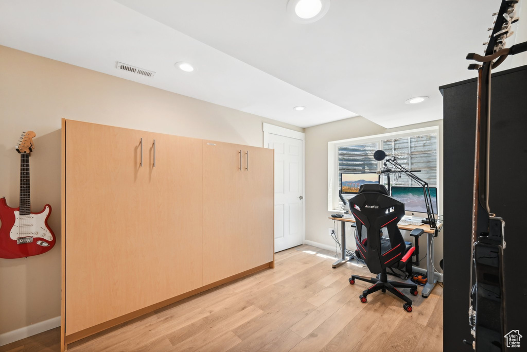 Office area with light hardwood / wood-style flooring