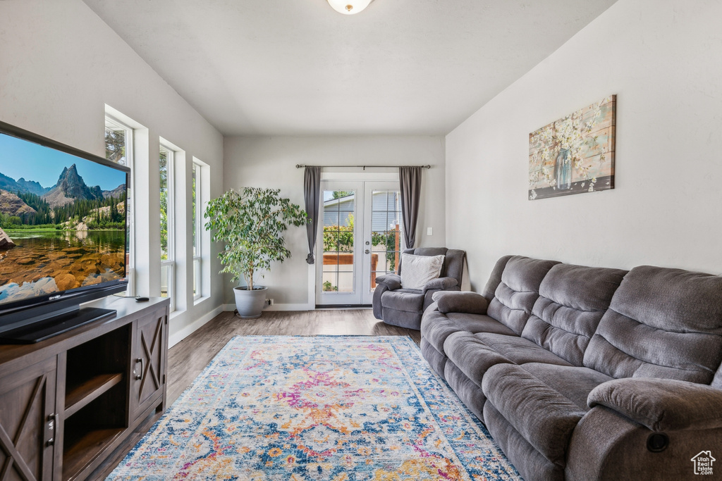 Living room with french doors and hardwood / wood-style floors