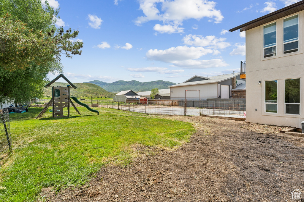 View of yard with a playground and a mountain view