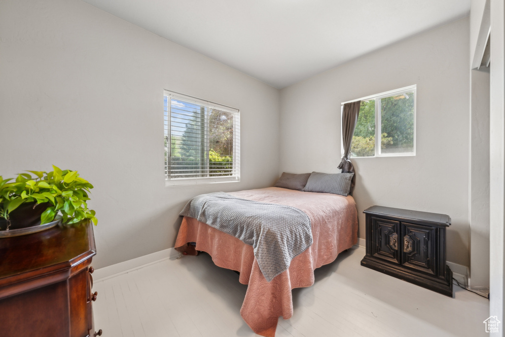 Bedroom with wood-type flooring and multiple windows