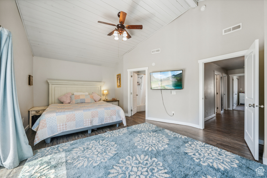 Bedroom with high vaulted ceiling, ceiling fan, and dark wood-type flooring