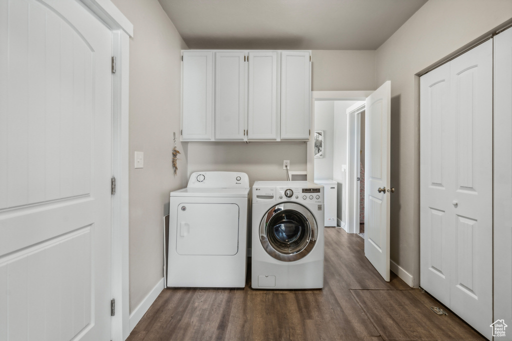 Laundry area with dark wood-type flooring, cabinets, independent washer and dryer, and hookup for a washing machine