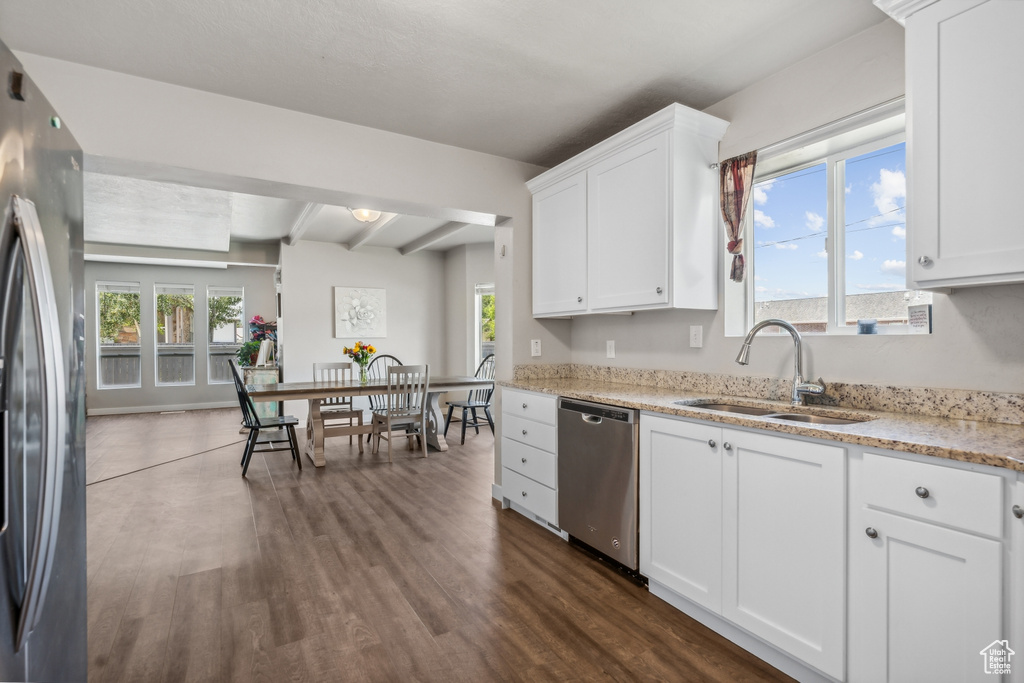 Kitchen with beam ceiling, dishwasher, dark hardwood / wood-style flooring, sink, and refrigerator