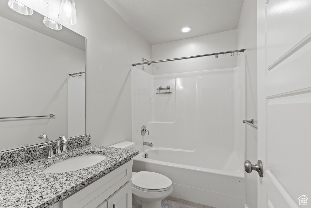 Full bathroom featuring bathtub / shower combination, toilet, and vanity