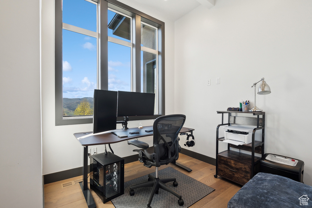 Office space with wood finished floors and baseboards