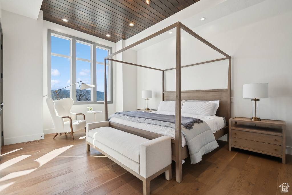 Bedroom with wood-type flooring, recessed lighting, wood ceiling, and baseboards