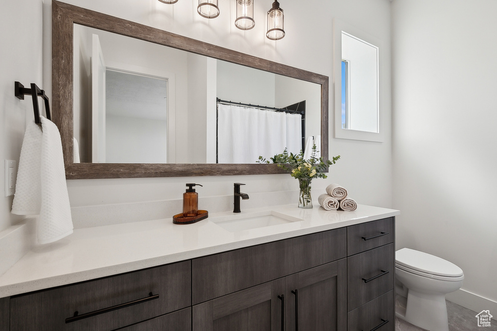 Full bathroom featuring vanity and toilet