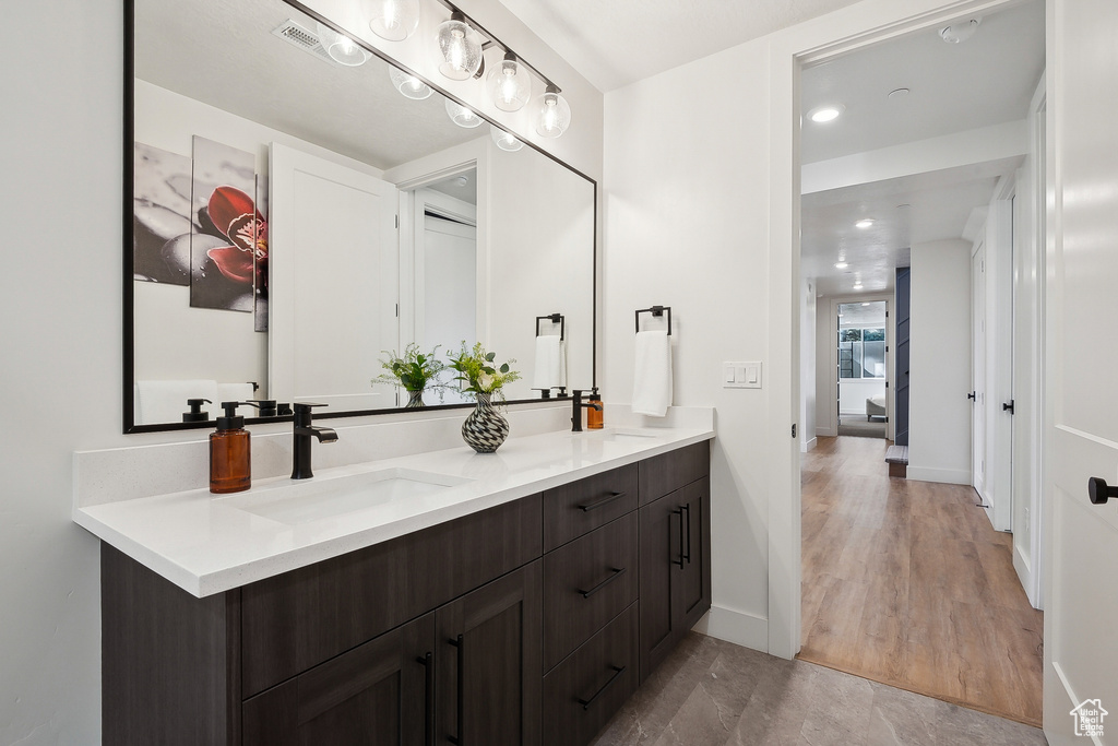 Bathroom with double vanity and baseboards
