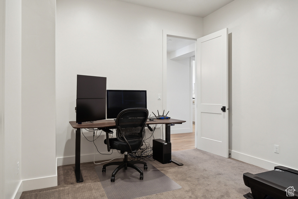 Office area featuring carpet and baseboards