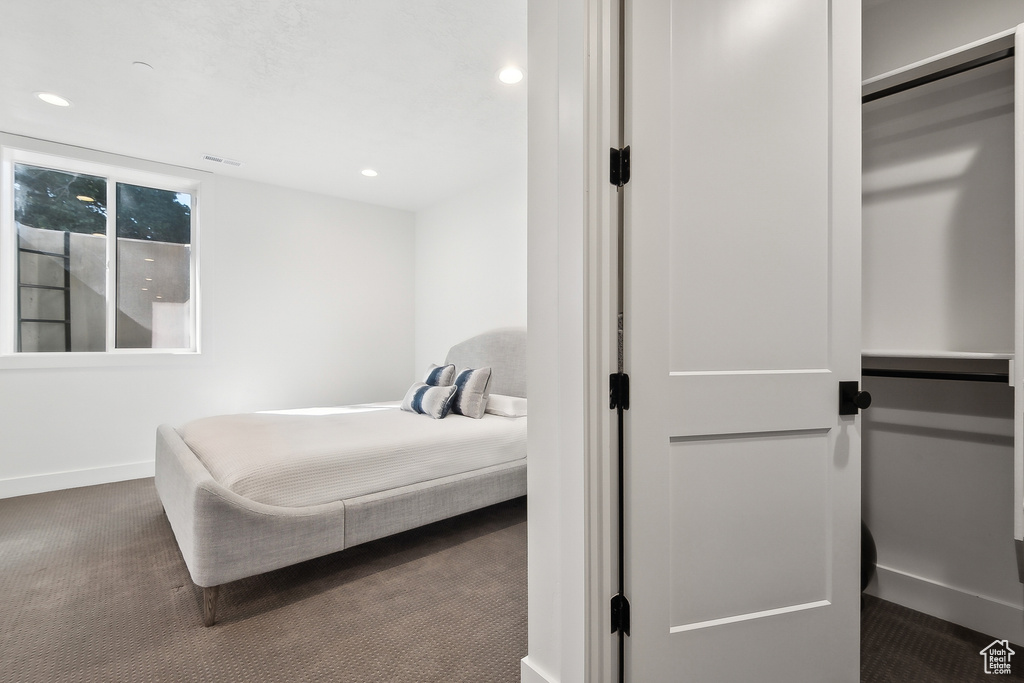 Carpeted bedroom featuring baseboards and recessed lighting