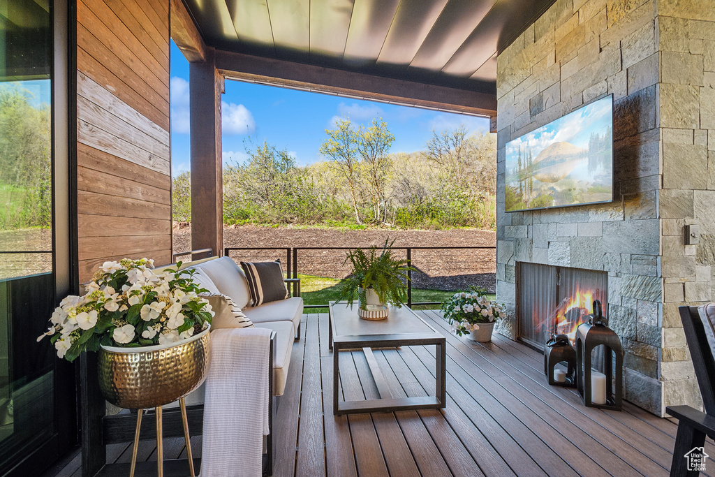 Deck featuring an outdoor living space with a fireplace