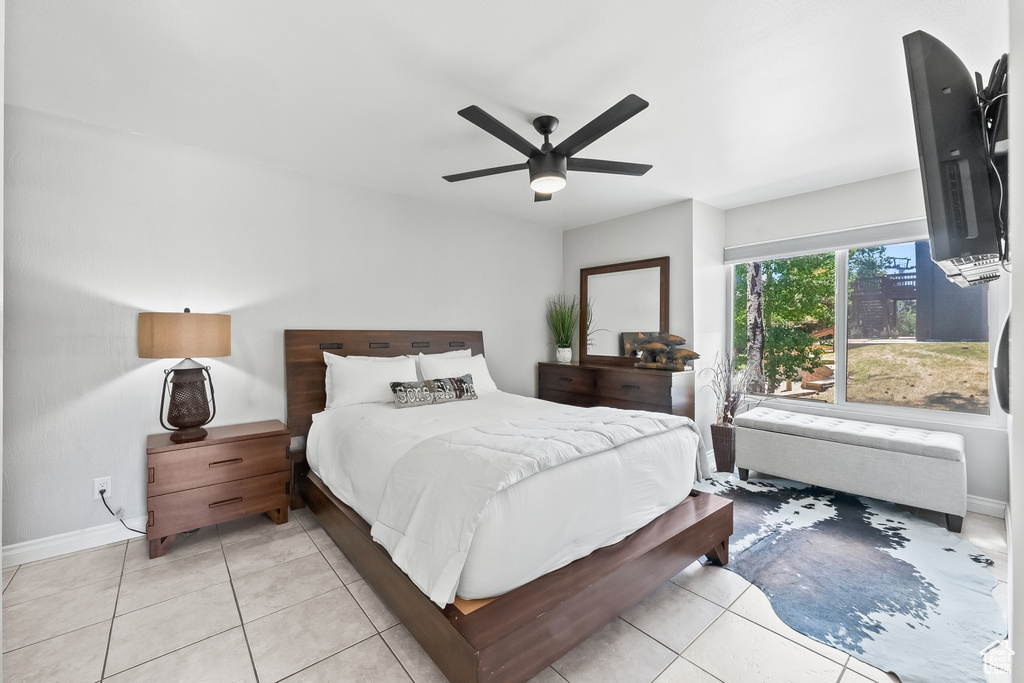 Bedroom with ceiling fan and light tile floors