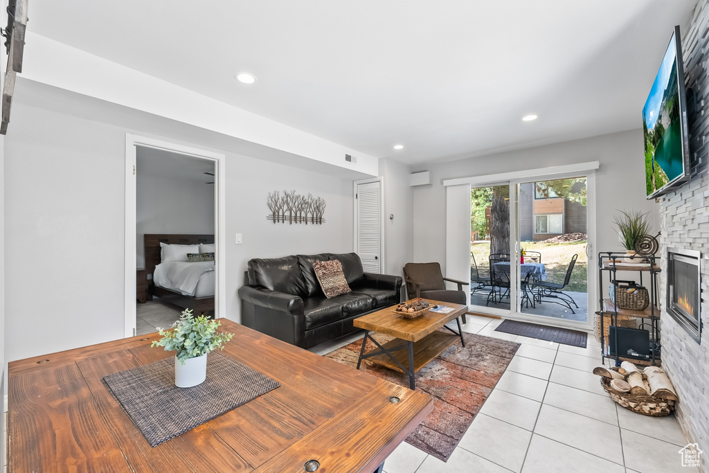 Tiled living room with a large fireplace