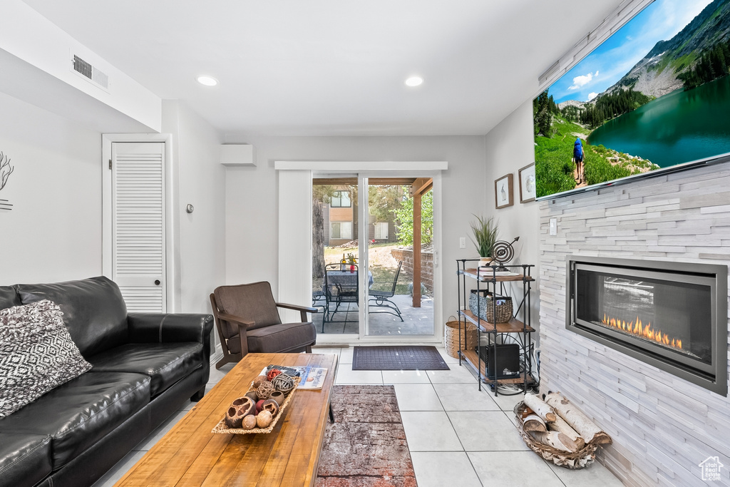 Living room featuring a fireplace and light tile flooring