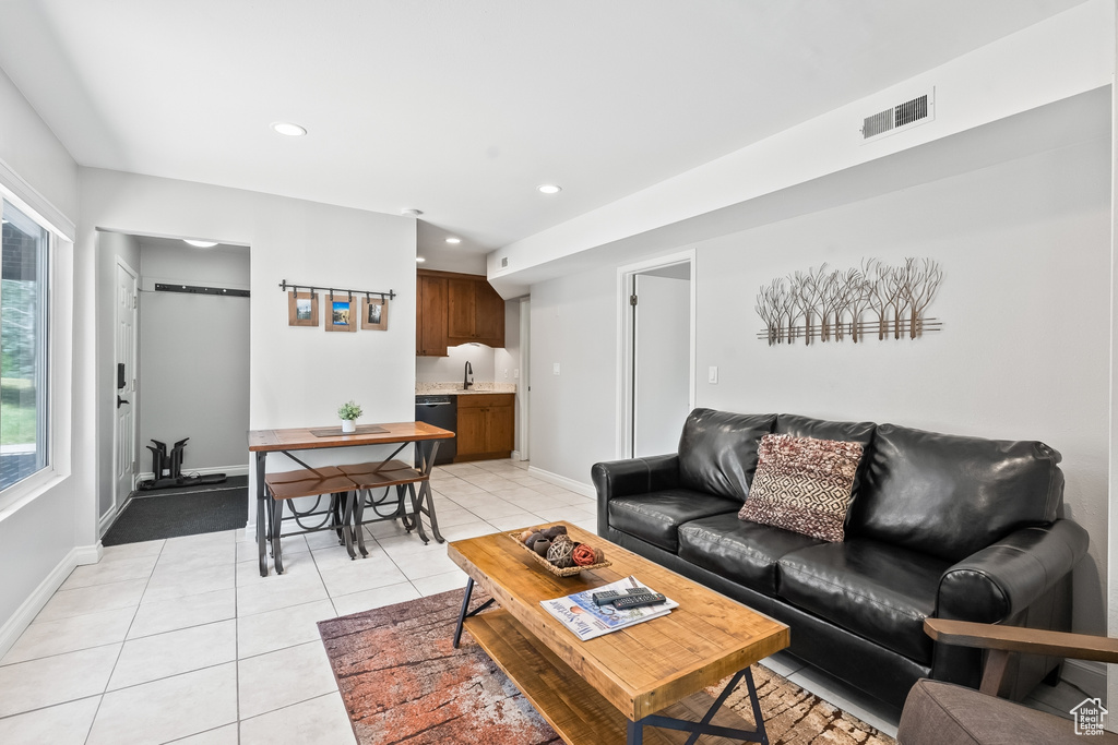 Living room featuring a barn door and light tile flooring