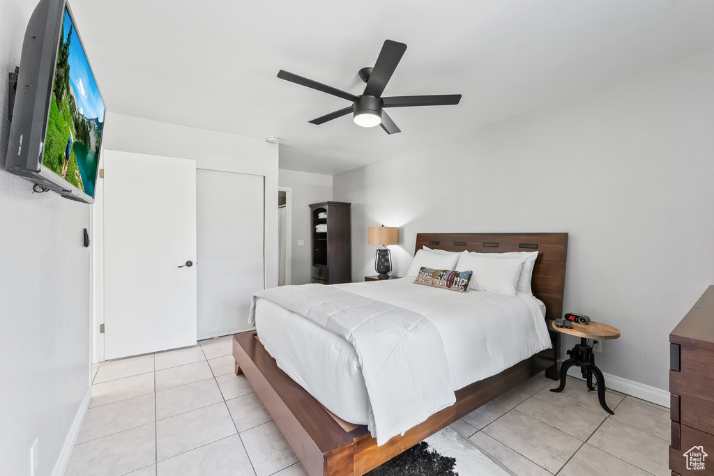 Bedroom featuring light tile flooring and ceiling fan