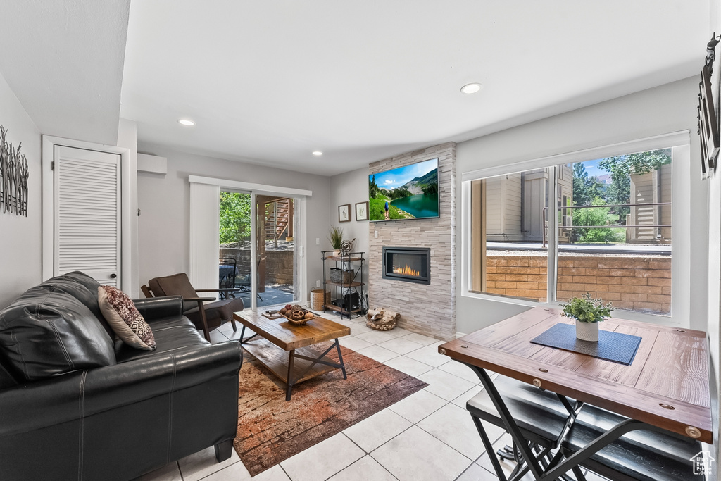 Tiled living room with a stone fireplace