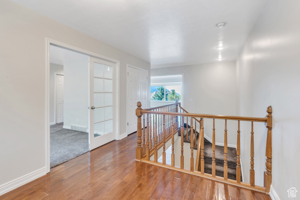 Corridor with carpet flooring and french doors