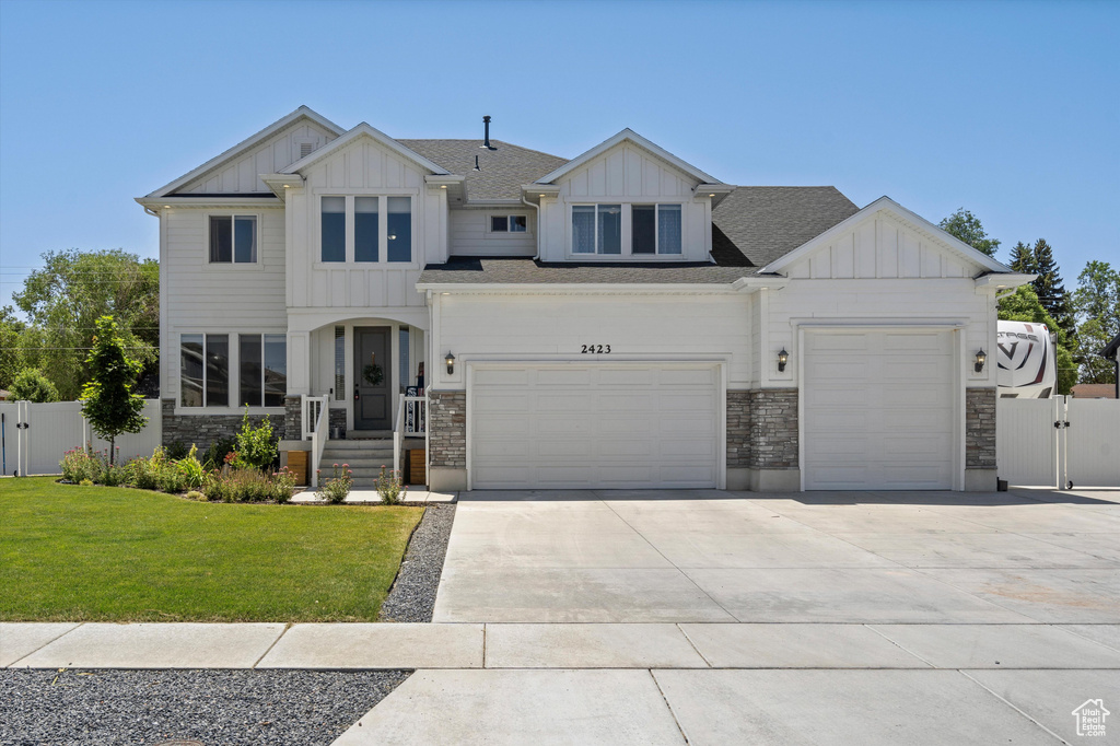 View of front of home featuring a garage and a front lawn