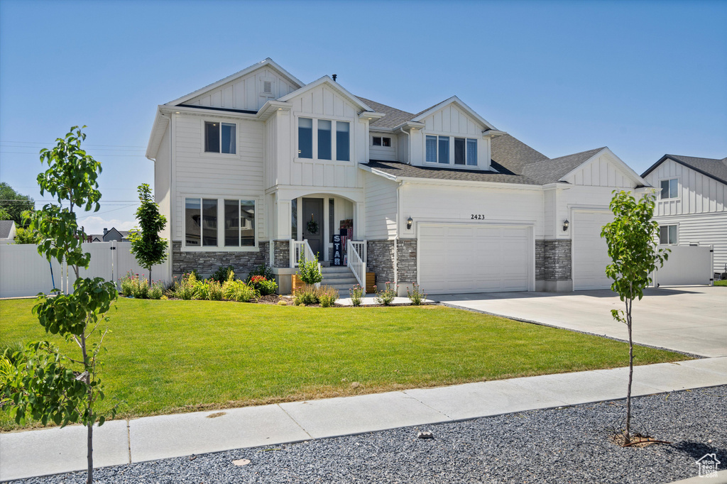 View of front of house featuring a garage and a front lawn