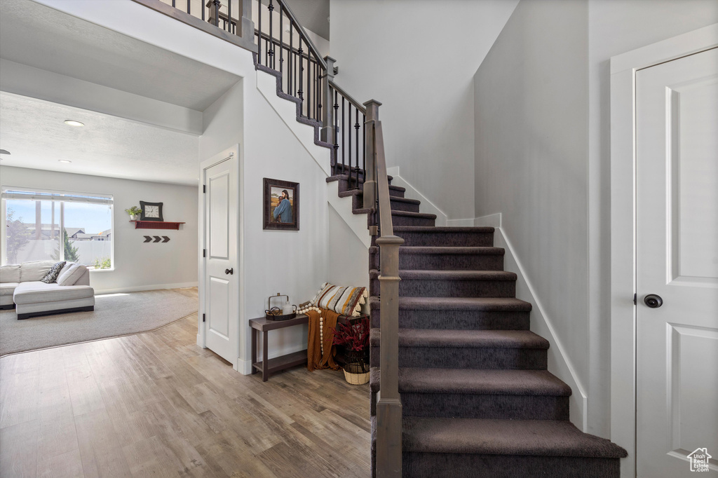 Stairway featuring wood-type flooring