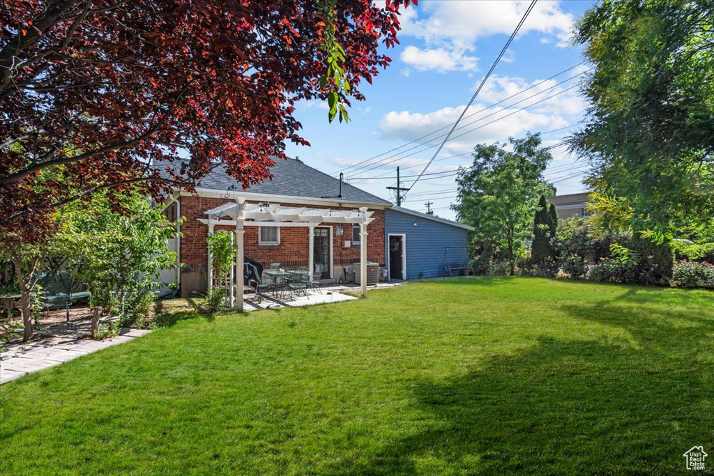 View of yard featuring a patio and a pergola