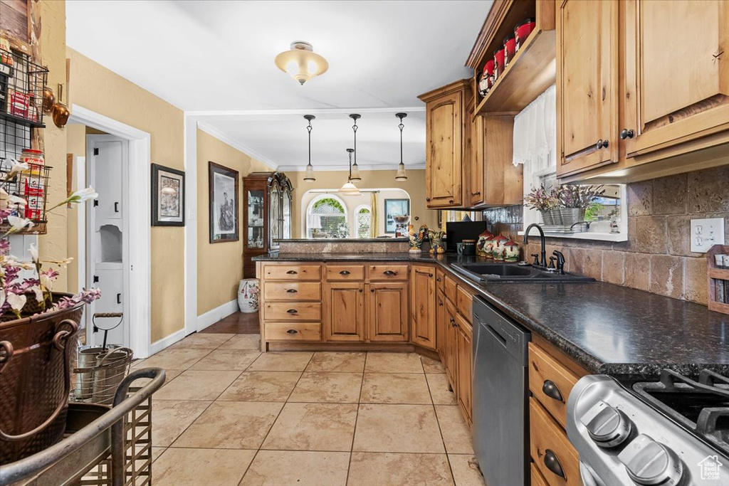 Kitchen with tasteful backsplash, dishwasher, pendant lighting, light tile floors, and sink