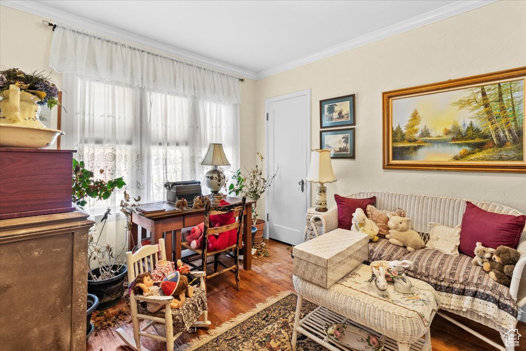 Home office with dark wood-type flooring and ornamental molding