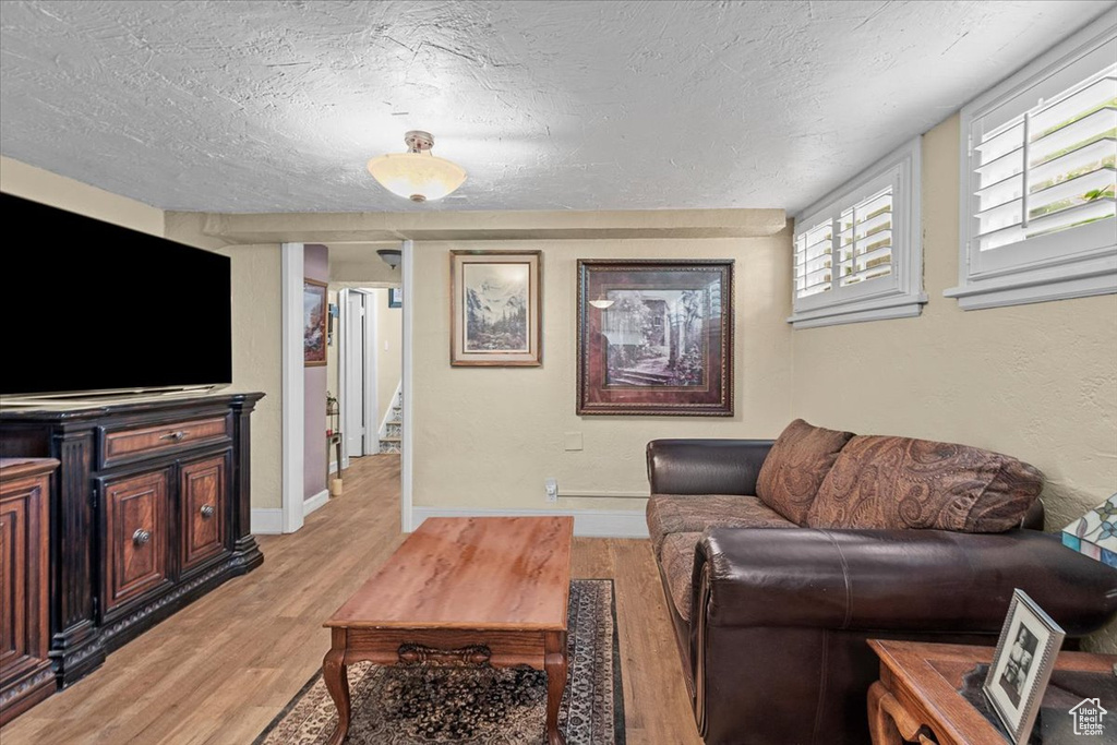 Living room with hardwood / wood-style floors and a textured ceiling