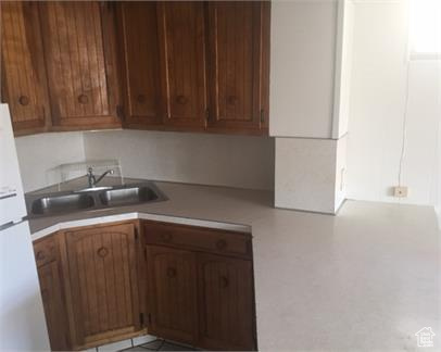 Kitchen featuring sink and white fridge