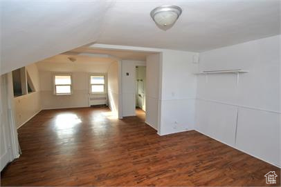 Bonus room featuring dark wood-type flooring