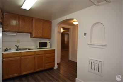 Kitchen with sink and dark hardwood / wood-style floors