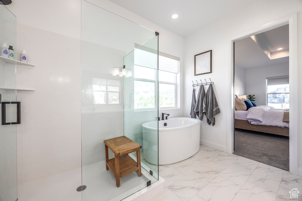 Bathroom with tile floors and separate shower and tub