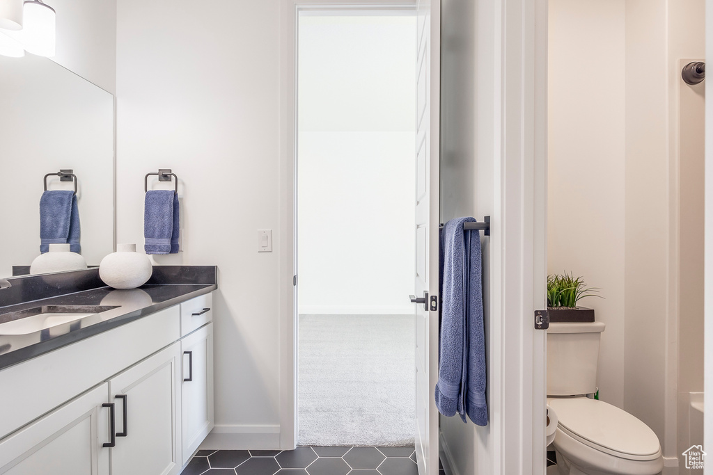 Bathroom featuring tile flooring, toilet, and vanity