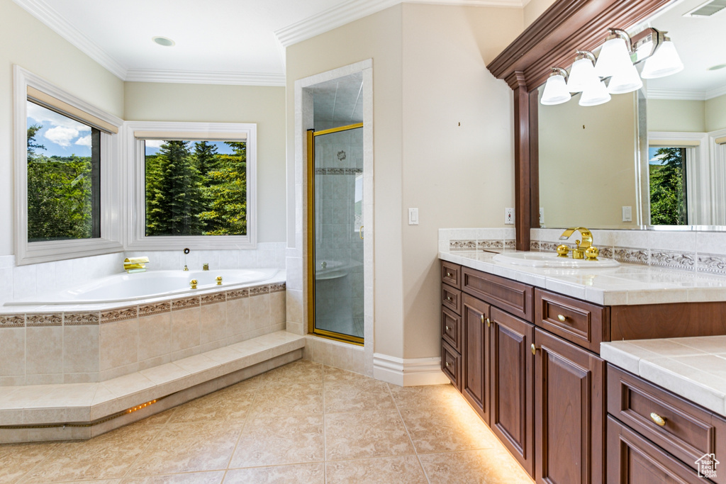 Bathroom with tile flooring, a healthy amount of sunlight, and large vanity