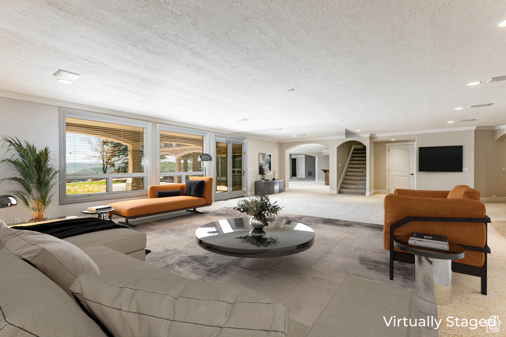 Living room with carpet, ornamental molding, and a textured ceiling