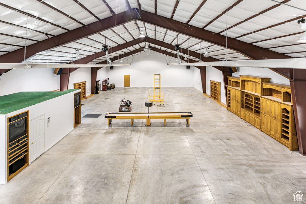 Interior space with concrete flooring and lofted ceiling