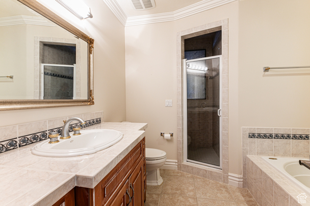 Full bathroom featuring vanity with extensive cabinet space, independent shower and bath, tile floors, and crown molding