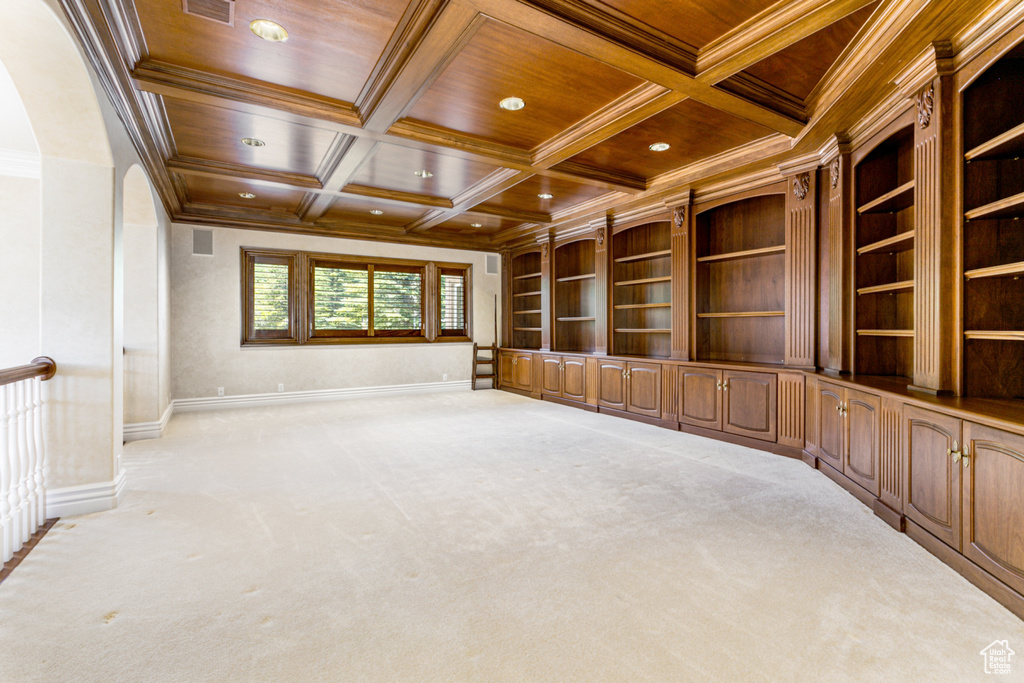 Spare room with carpet, coffered ceiling, wood ceiling, and crown molding