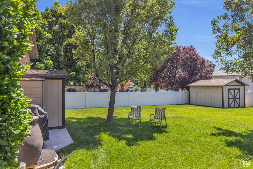 View of yard featuring a storage unit