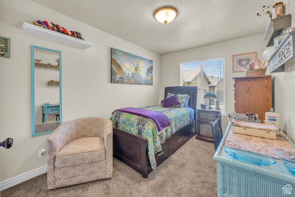 Bedroom with carpet and a textured ceiling