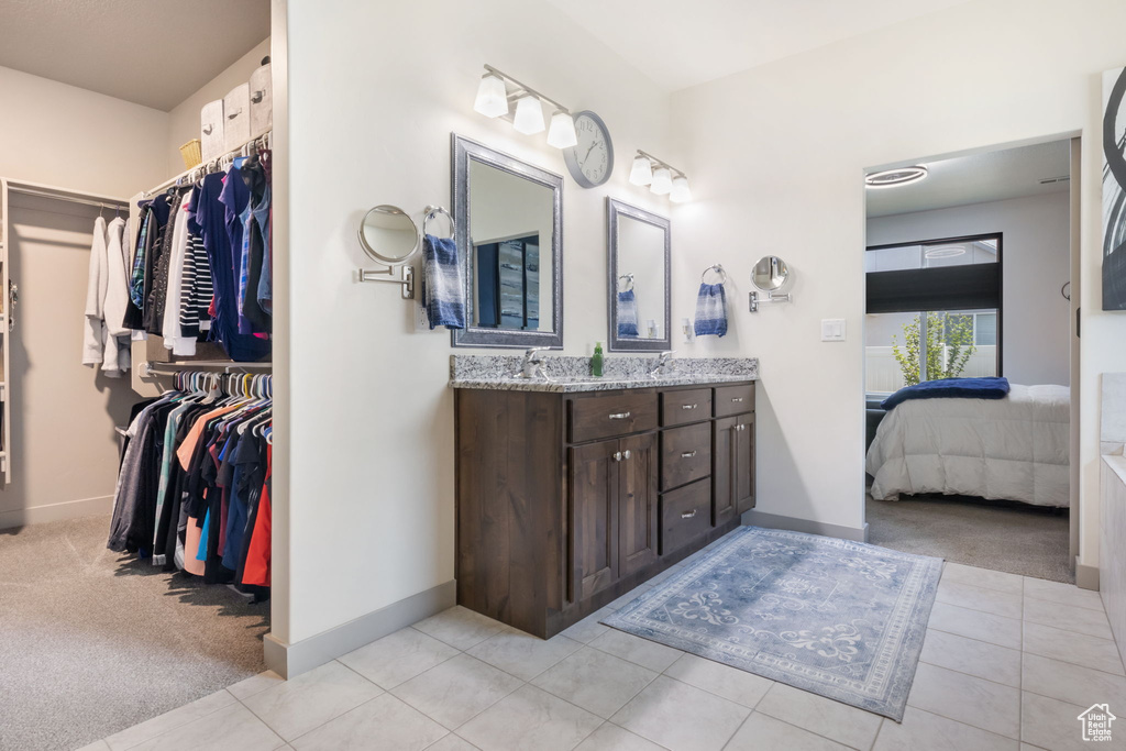 Bathroom featuring vanity and tile floors