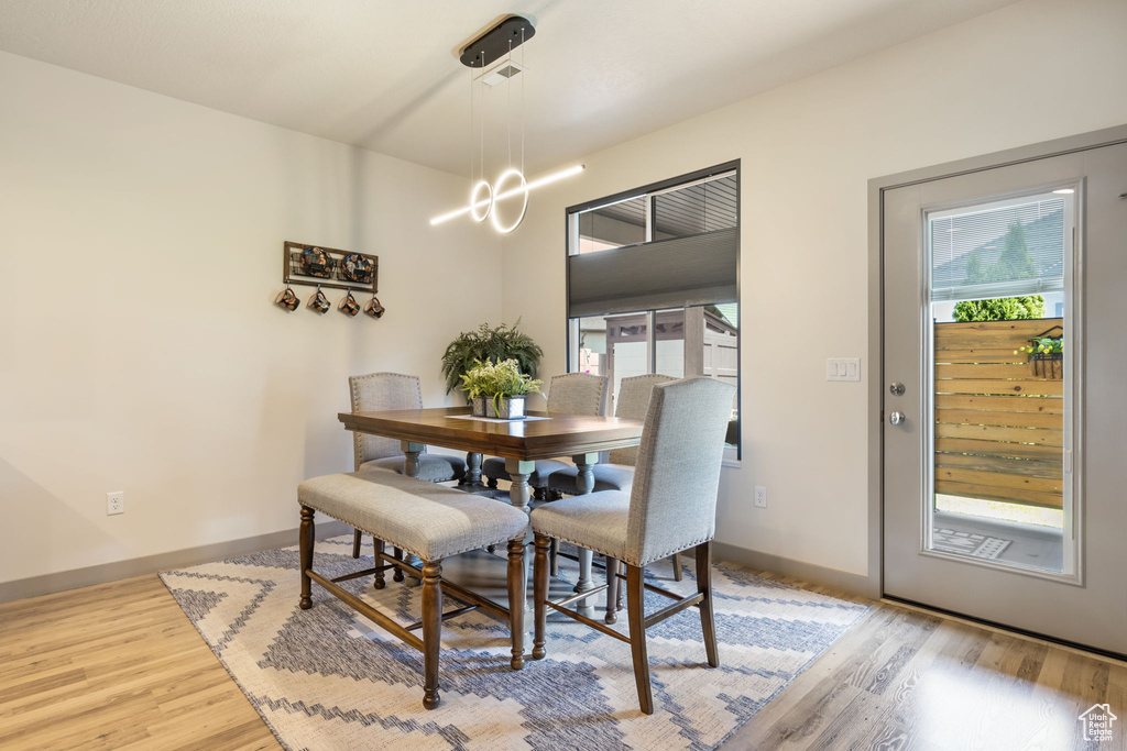 Dining space featuring a notable chandelier and wood-type flooring