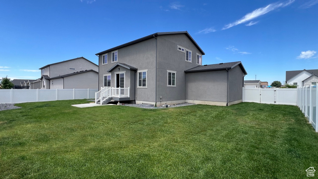 Back of house featuring a lawn